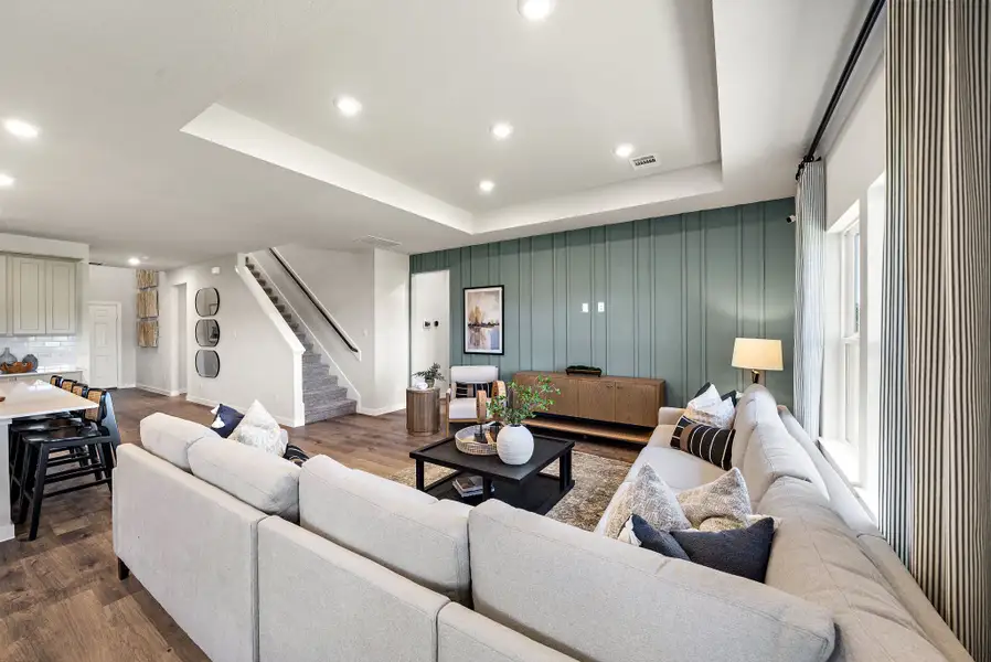 A large living room with a staircase.