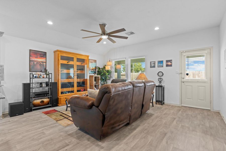 Alternate view highlights the seamless connection between the family area! Notice the large, upgraded ceiling fan and plus the bright windows that overlook the private backyard, creating a cheerful and airy atmosphere. Alternate view highlights the seamless connection between the family area! Notice the large, upgraded ceiling fan and plus the bright windows that overlook the private backyard, creating a cheerful and airy atmosphere.