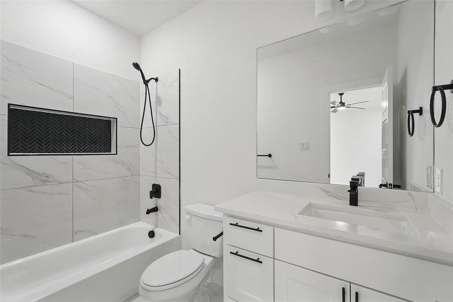 Full bath featuring toilet, vanity, and tub / shower combination Full bath featuring toilet, vanity, and tub / shower combination