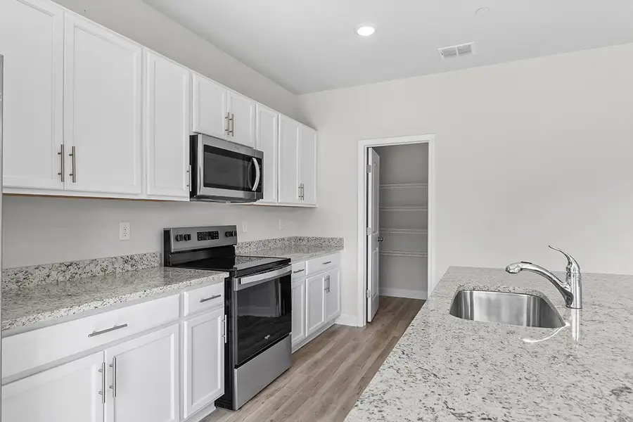 A kitchen with white cabinets. A kitchen with white cabinets.