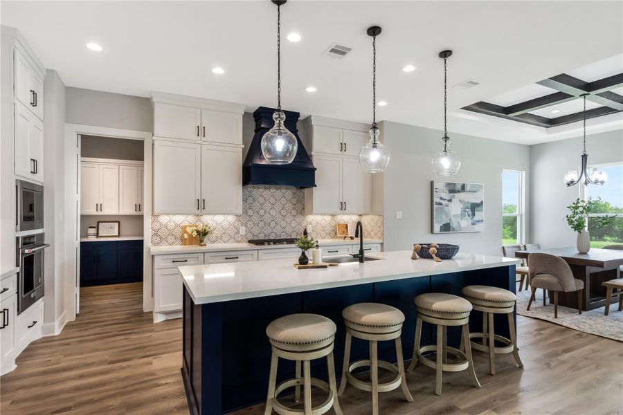 Stunning designer kitchen featuring elegant dark blue and white cabinetry.