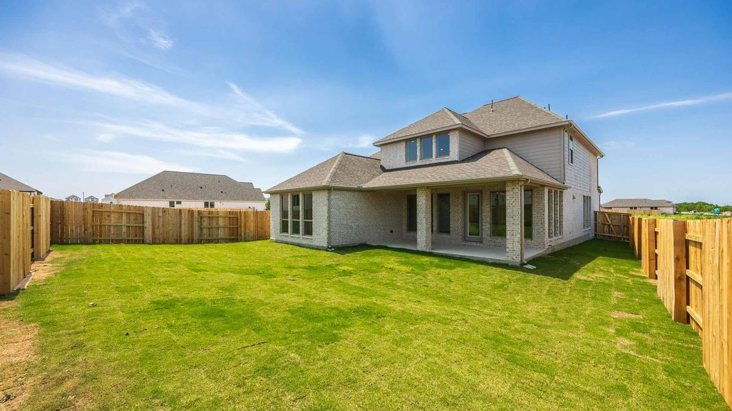 Rear view of property featuring roof with shingles, brick siding, and a patio Rear view of property featuring roof with shingles, brick siding, and a patio