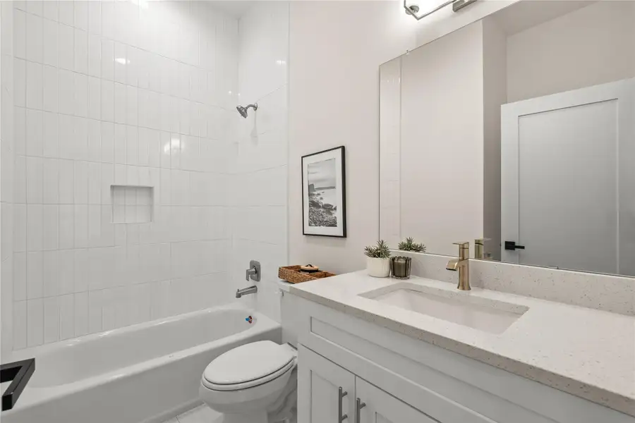 Full bath on the first floor with quartz vanity and tub/shower combo Full bath on the first floor with quartz vanity and tub/shower combo
