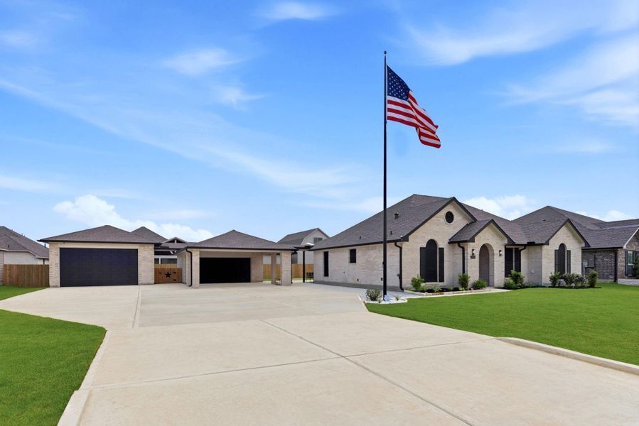 Front exterior of a new home in Pedregal, Dickinson, TX, highlighting curb appeal (Image 23).
