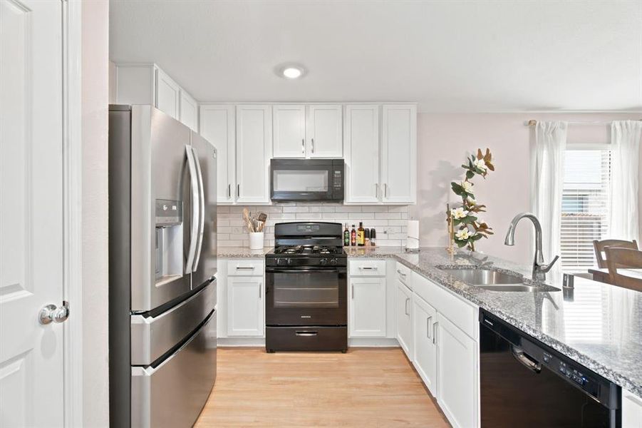 Bright white cabinets and granite countertops in the kitchen of 1028 Naranjos Dr, Haslet TX in Rancho Canyon