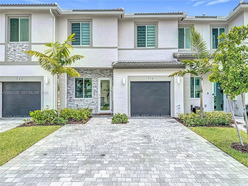 Front exterior of a new home in , Homestead, FL, highlighting curb appeal (Image 23).