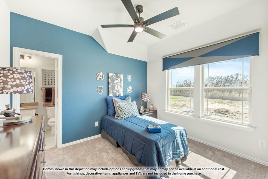 Children's bedroom with blue accent wall, vaulted ceiling, ceiling fan, and ensuite bathroom access