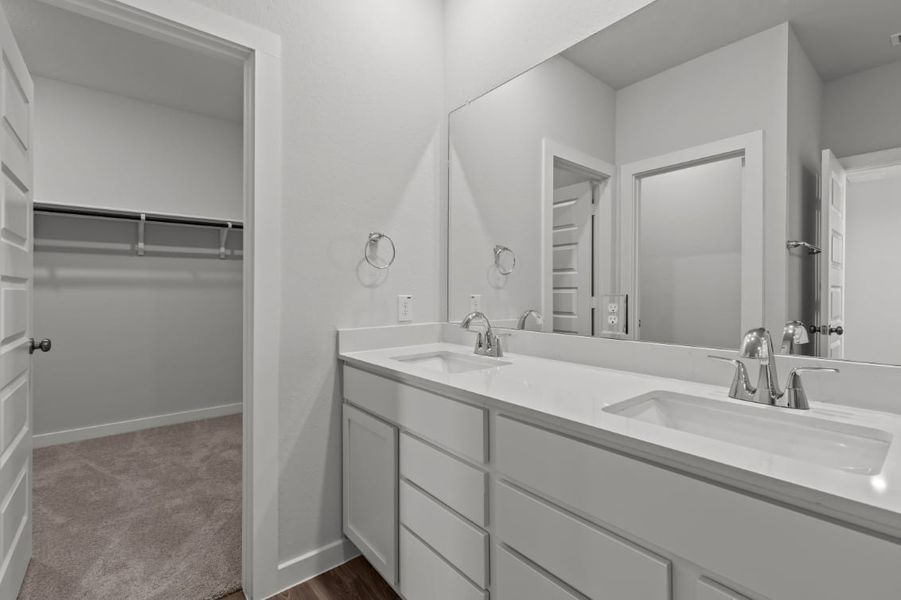 A bathroom with a large mirror.