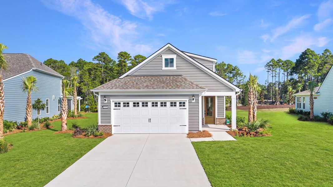 Front exterior of a new home in Del Webb Ocean Isle Beach, Shallotte, NC, highlighting curb appeal (Image 15).