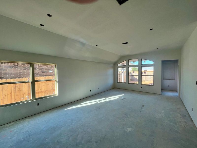 Empty room with concrete flooring and vaulted ceiling Empty room with concrete flooring and vaulted ceiling