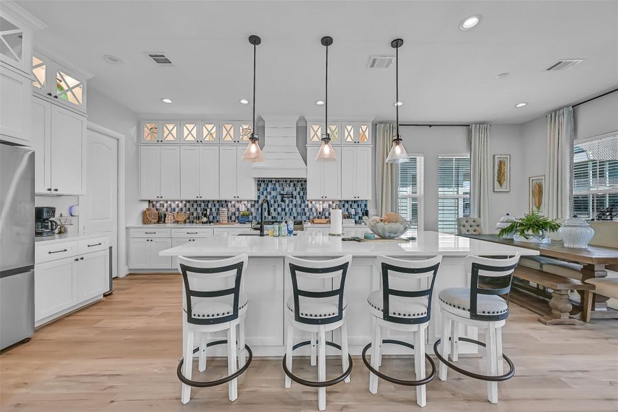 The oversized island instantly becomes the heart of the home with seating, prep space, and room to entertain. Buyers will appreciate both the design and functionality.  The elevated floor to ceiling cabinets make a statement!
