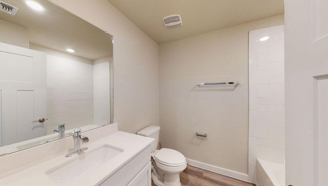 Full bath with vanity, light wood-type flooring, recessed lighting, and bathtub / shower combination