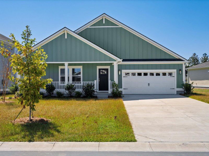 Front exterior of a new home in The Coves at Lakes of Cane Bay II, Summerville, SC, highlighting curb appeal (Image 1). Front exterior of a new home in The Coves at Lakes of Cane Bay II, Summerville, SC, highlighting curb appeal (Image 1).