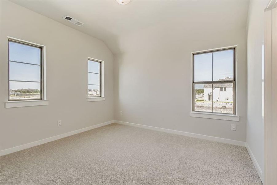 Carpeted empty room with baseboards