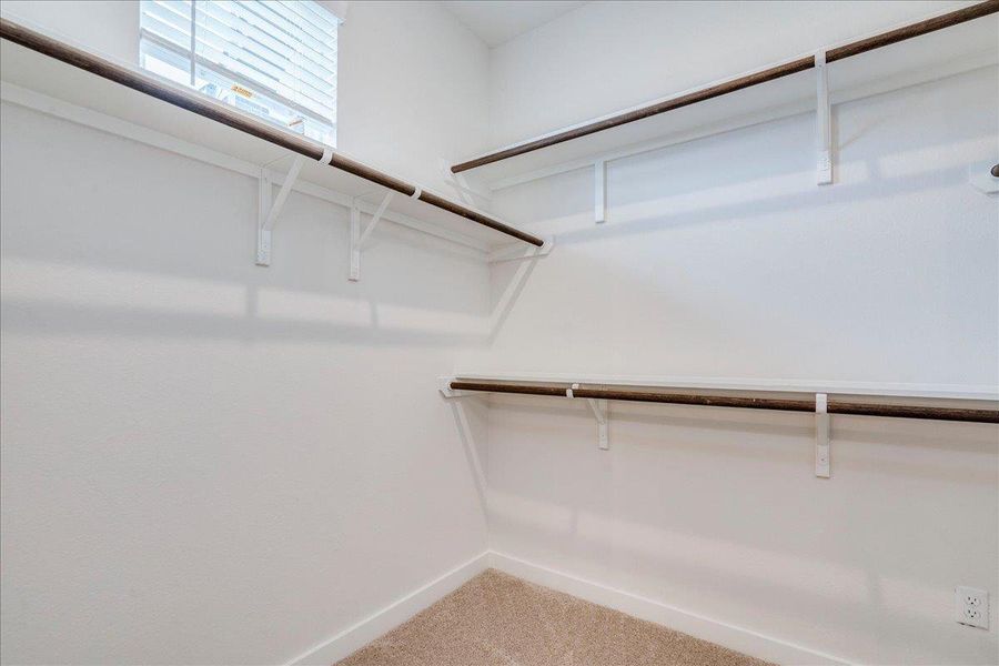 Functional shelving and hanging rods offer ample storage solutions for an organized wardrobe.