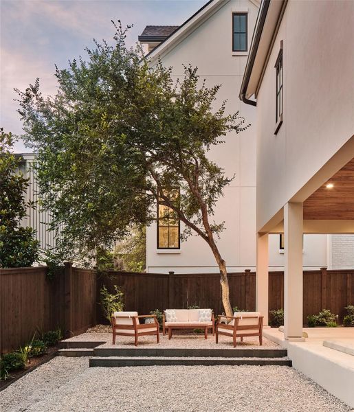 Backyard past the covered back porch with low maintenance steel terraced areas for outdoor furniture and entertaining.