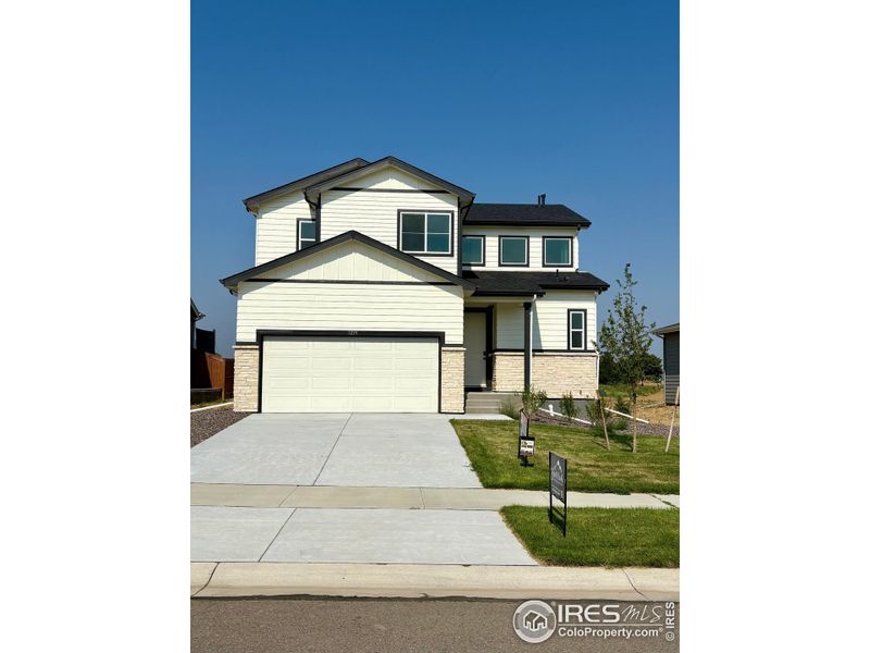 Front exterior of a new home in Promontory Point, Greeley, CO, highlighting curb appeal (Image 23). Front exterior of a new home in Promontory Point, Greeley, CO, highlighting curb appeal (Image 23).