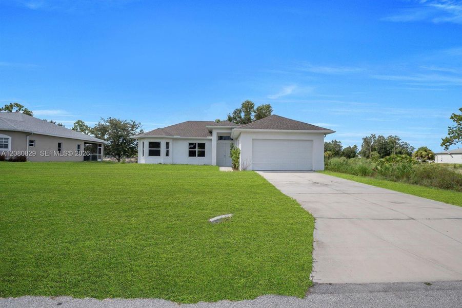 Front exterior of a new home in , Lehigh Acres, FL, highlighting curb appeal (Image 19).