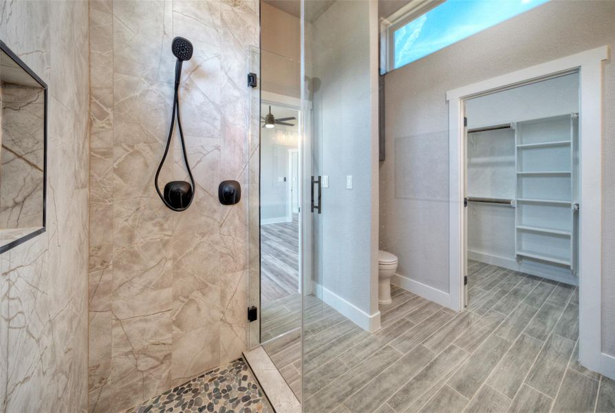 High clerestory windows bring natural light into this modern bathroom featuring a tiled walk-in shower. High clerestory windows bring natural light into this modern bathroom featuring a tiled walk-in shower.