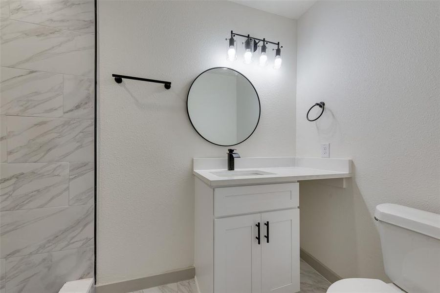 Bathroom with oversized vanity and toilet