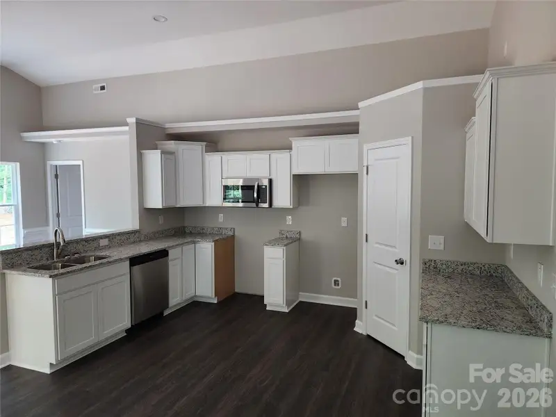 Decorative Kitchen w/ Granite Tops, SS Appliances and Walk in Pantry, Plant Shelf Above