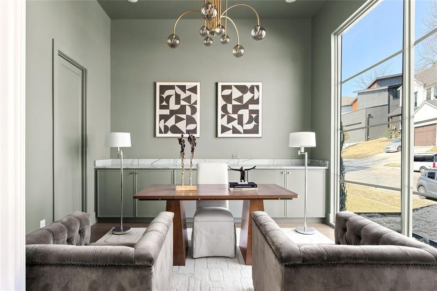 Floor-to-ceiling window offering extensive natural light, complemented by a contemporary chandelier