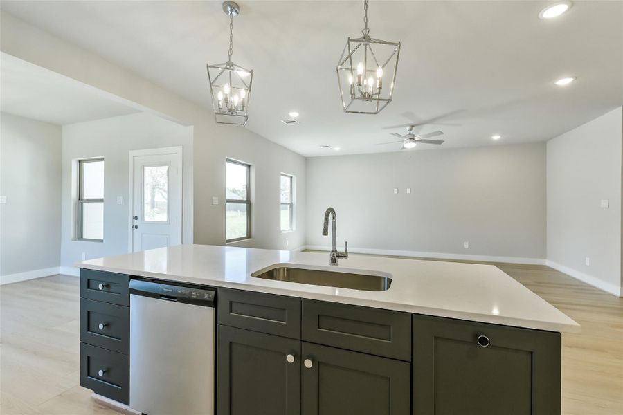 Functional island offers a central workspace and view of the main living area, blending style and practicality in the heart of the home.