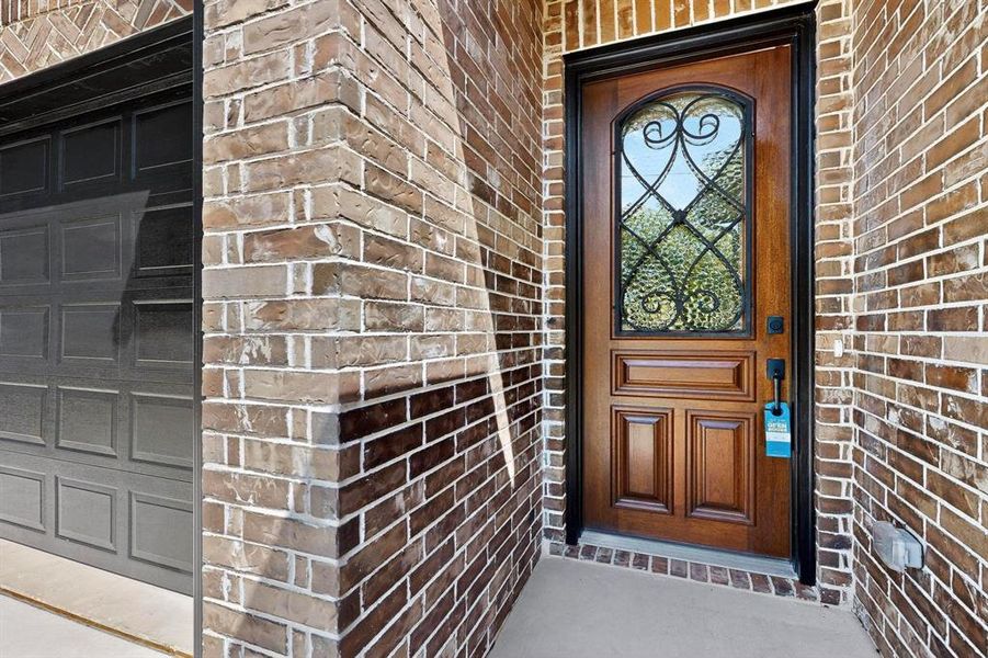 Doorway to property featuring brick siding