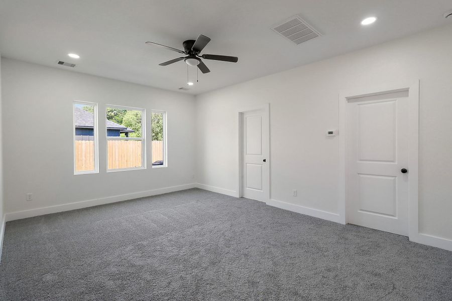 Continuing on the first floor, the primary bedroom sits at the back and is oversized.