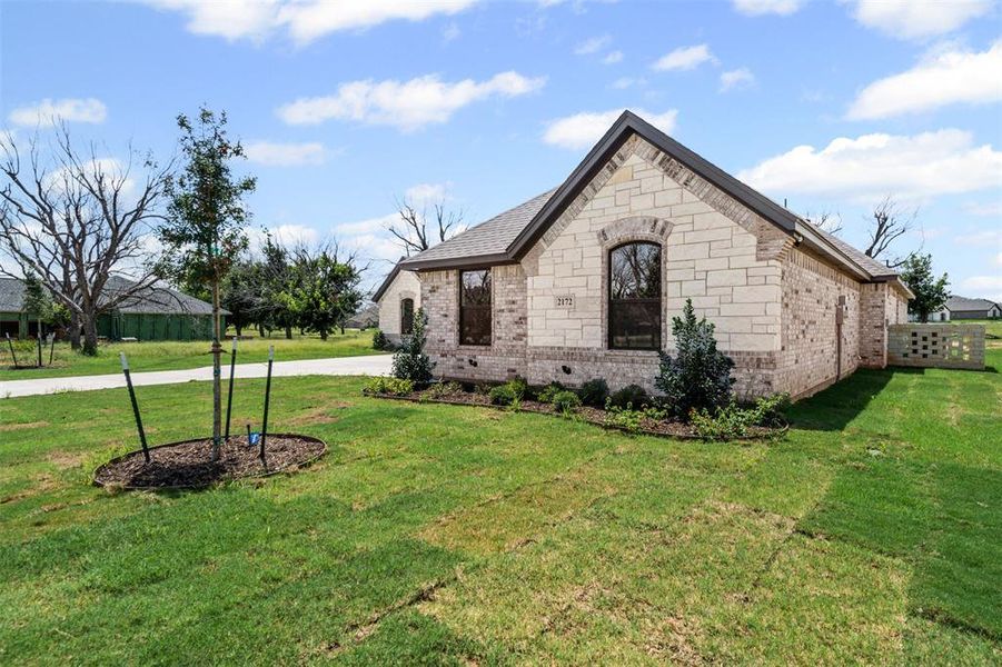 Front exterior of a new home in Pecan Plantation, Granbury, TX, highlighting curb appeal (Image 2).