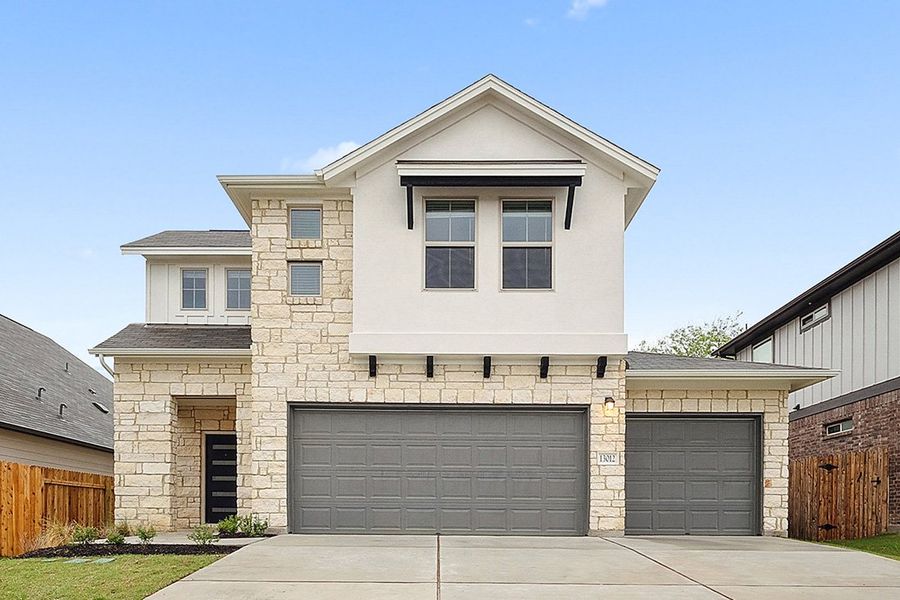 Front exterior of a new home in The Hills of Bear Creek, Manchaca, TX, highlighting curb appeal (Image 21).