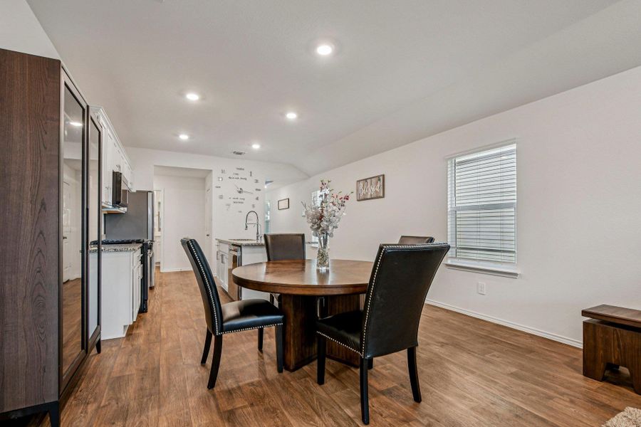 Dining space featuring recessed lighting and dark wood-type flooring