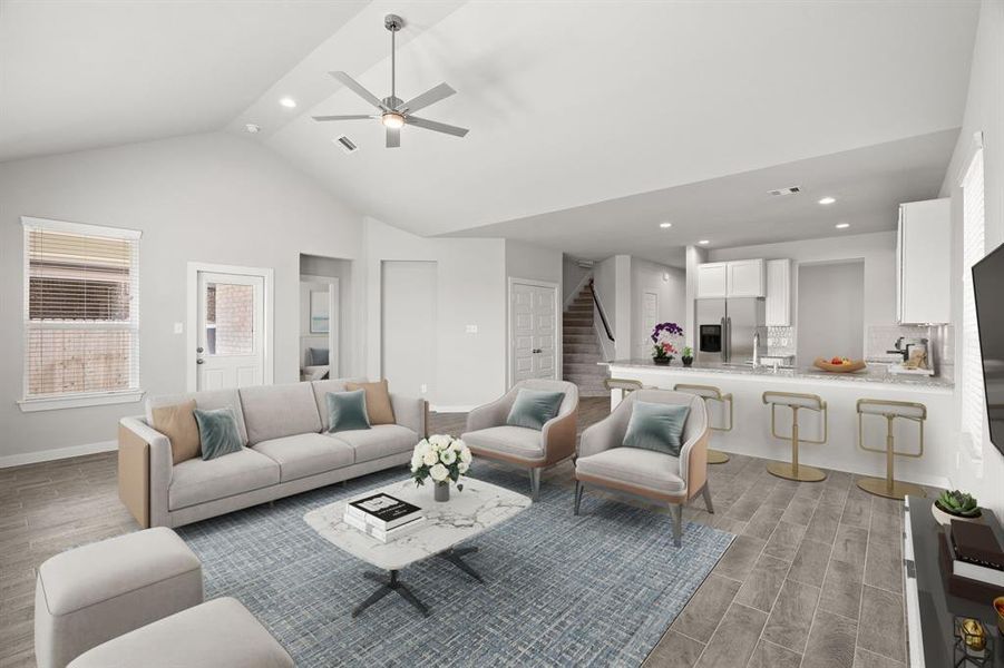 Bring your loved ones and guests together in the inviting living room! Sample photo of completed home with similar floor plan. As-built interior colors and selections may vary.