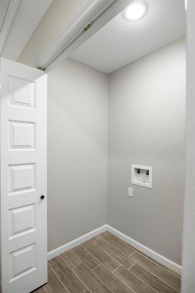 Laundry room with wood finish floors and washer hookup Laundry room with wood finish floors and washer hookup