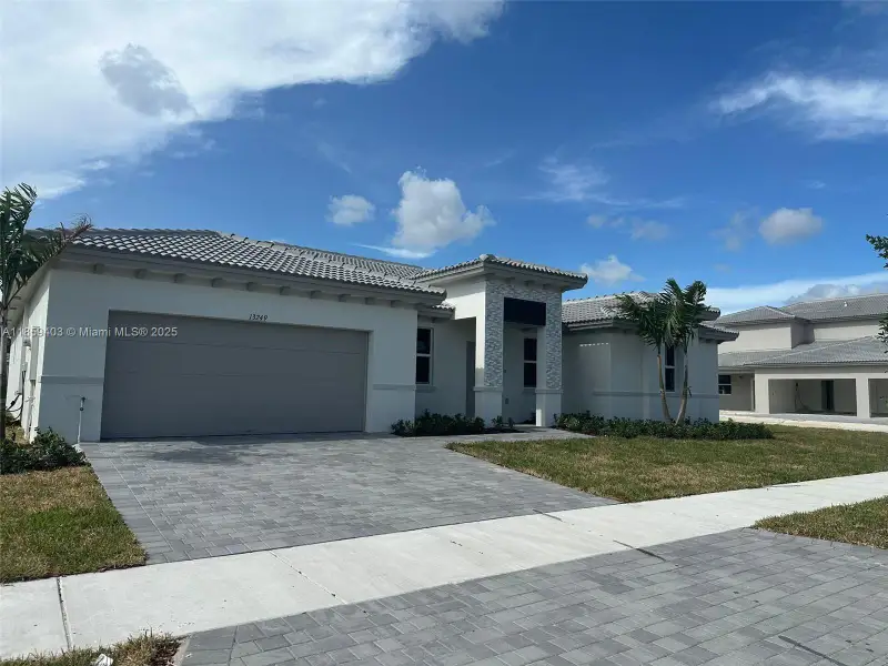 Front exterior of a new home in Hawthorne at Galiano Pointe, Miami, FL, highlighting curb appeal (Image 1).