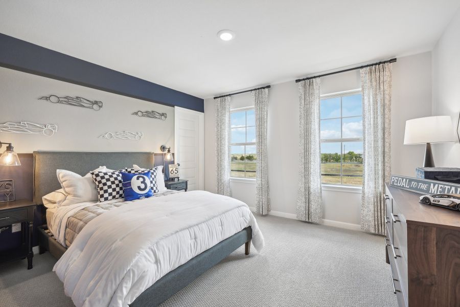 A bedroom with a large window.
