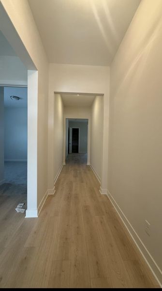 Hall featuring baseboards and light wood-style flooring