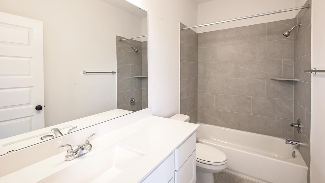 Bathroom featuring bathing tub / shower combination and vanity