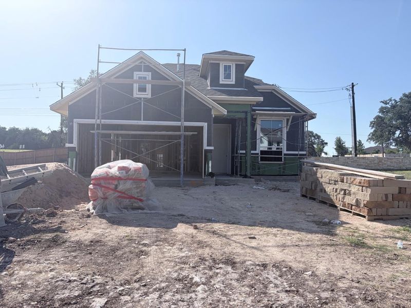 Under-construction residence showcasing durable construction materials and a practical garage space. Under-construction residence showcasing durable construction materials and a practical garage space.