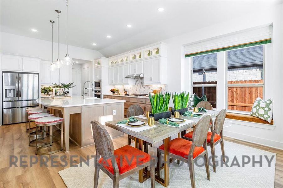 Dining space with vaulted ceiling, light wood-type flooring, and recessed lighting Dining space with vaulted ceiling, light wood-type flooring, and recessed lighting