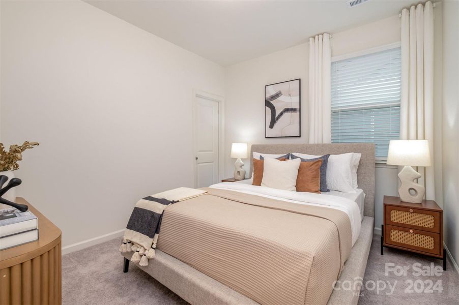 secondary bedroom with walk-in closet