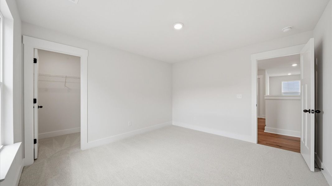 Secondary bedroom with spacious walk-in closet and thoughtful design at the reputable Iris Meadows community