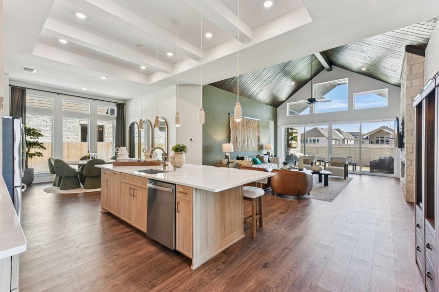 Soaring vaulted ceilings and a sprawling open layout define this custom modern living space.