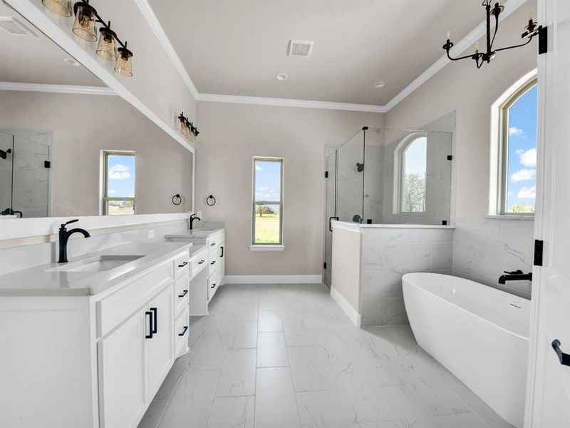 Bathroom with crown molding, a shower stall, marble finish floor, a sink, and double vanity Bathroom with crown molding, a shower stall, marble finish floor, a sink, and double vanity
