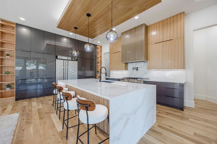 Kitchen featuring modern cabinets, recessed lighting, a breakfast bar area, hanging light fixtures, and wood ceiling Kitchen featuring modern cabinets, recessed lighting, a breakfast bar area, hanging light fixtures, and wood ceiling