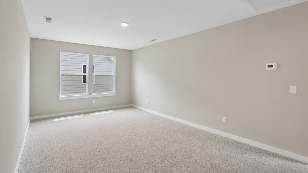 Second Floor Loft area with windows and carpet Second Floor Loft area with windows and carpet