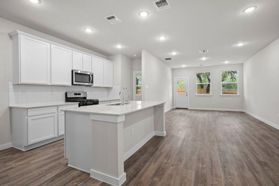 A kitchen with white cabinets.