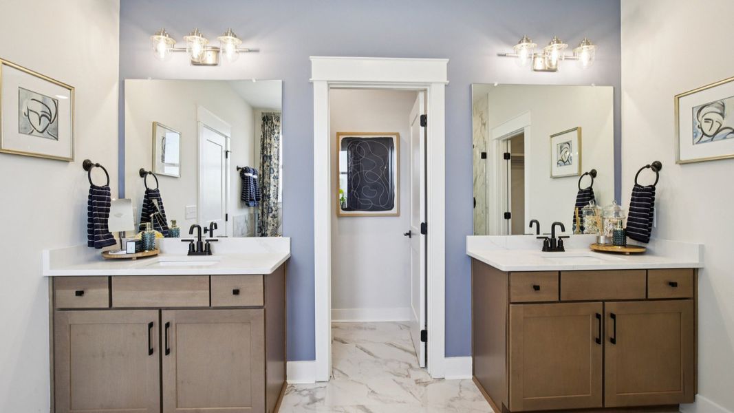 Split dual vanities on either side of water closet, and nearby walk-in closet