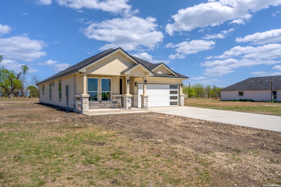 Front exterior of a new home in , Atascosa, TX, highlighting curb appeal (Image 22).