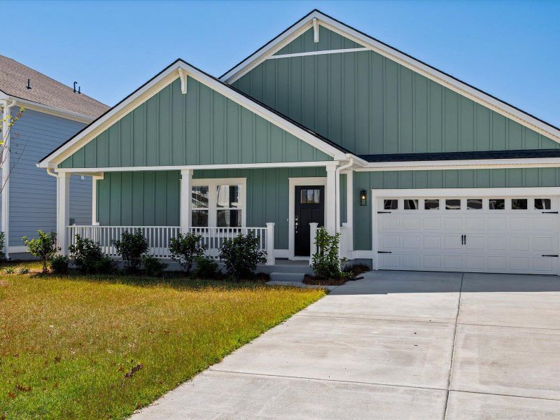 Front exterior of a new home in The Coves at Lakes of Cane Bay II, Summerville, SC, highlighting curb appeal (Image 2). Front exterior of a new home in The Coves at Lakes of Cane Bay II, Summerville, SC, highlighting curb appeal (Image 2).